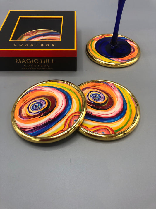 Handmade ceramic coasters with brass trim and velvet on the bottom. art by Bruce Mishell Exclusivity sold by Magic Hill Hudson. 4” inches