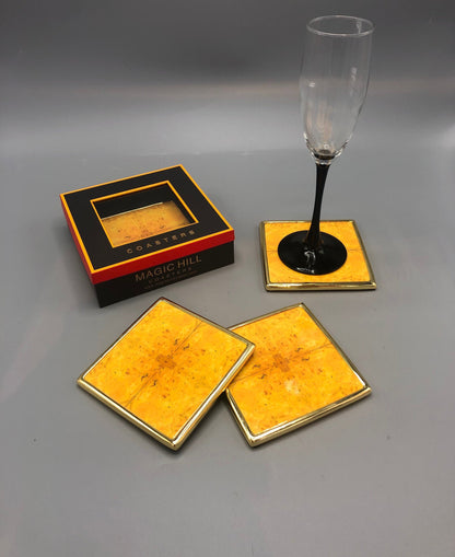 Handmade ceramic coasters with brass trim and velvet bottom. Art by Bruce Mishell