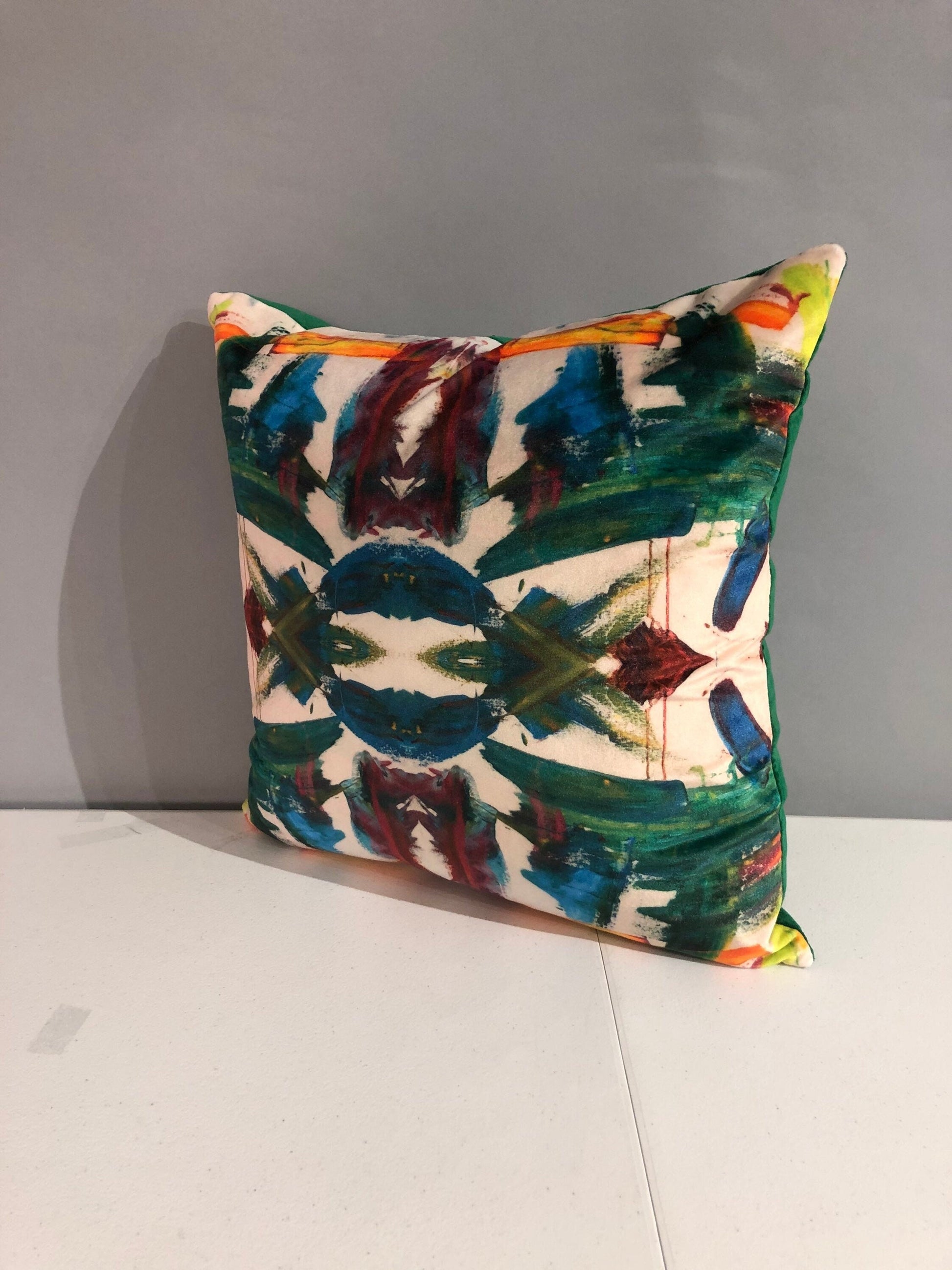 Contemporary abstract kaleidoscope pillows with print on velvet with green velvet in the back 16” x 16” inches