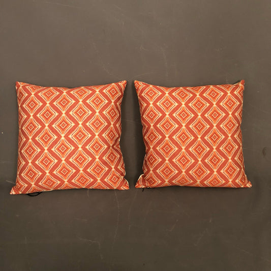 Pair of new hand made modern pillows with geometric orange design.