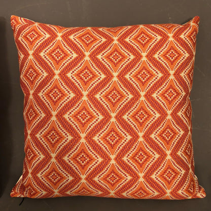 Pair of new hand made modern pillows with geometric orange design.