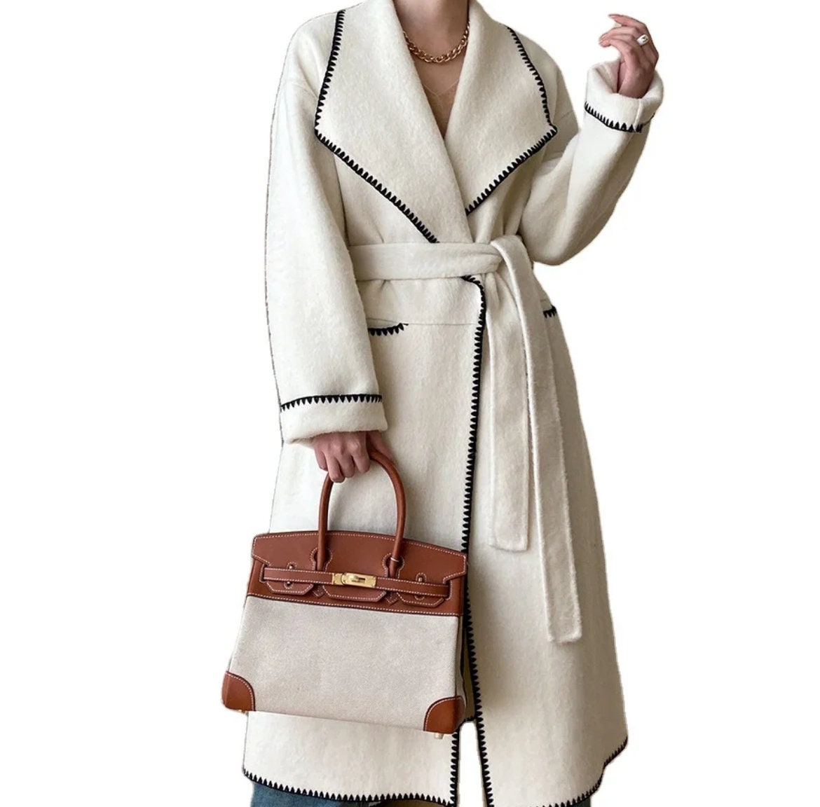 Double breasted hand sew coat in cream with black trim contrast color