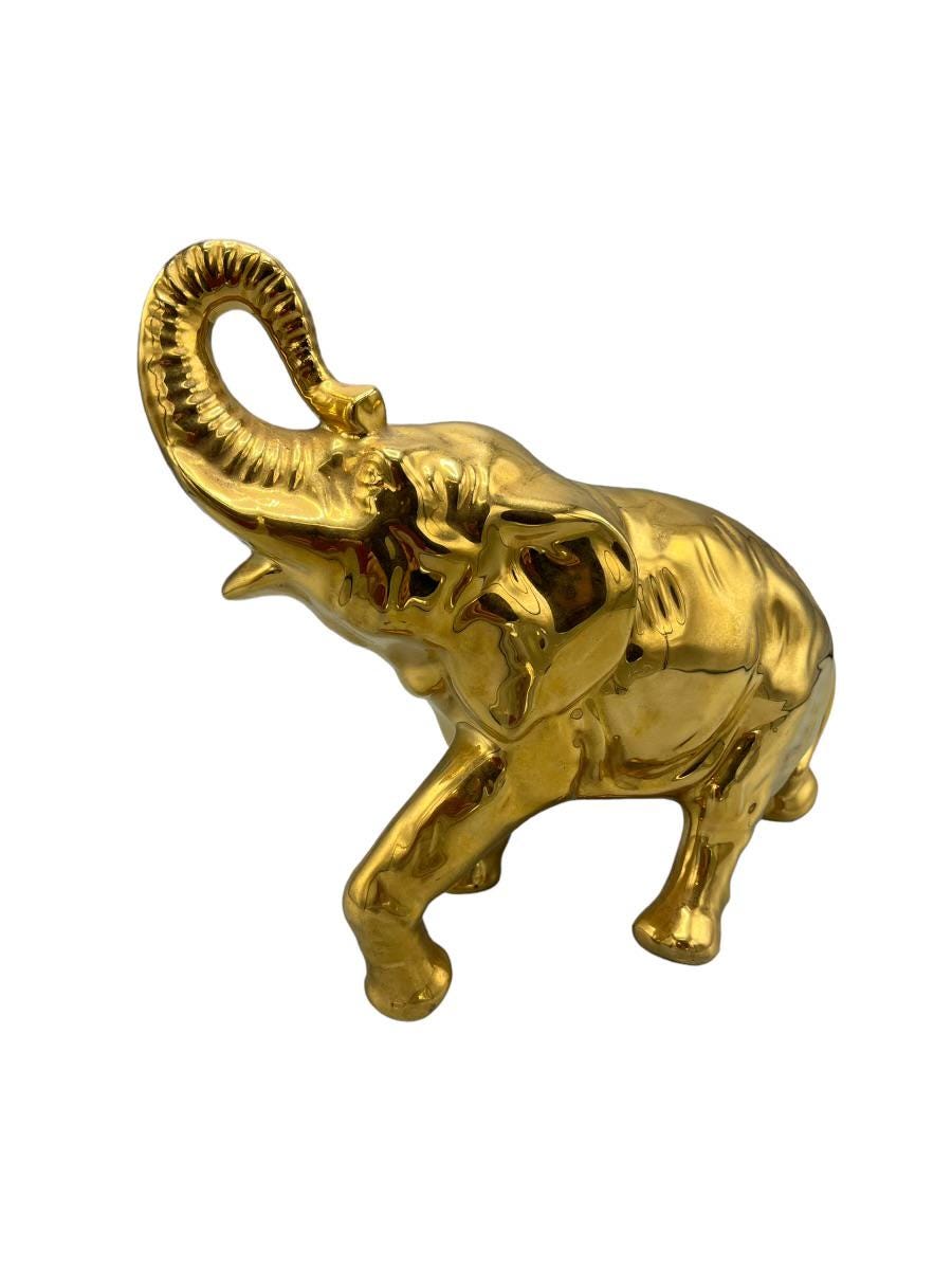 Decorative elephant figurine finished in a shiny gold color and symbolizing good luck