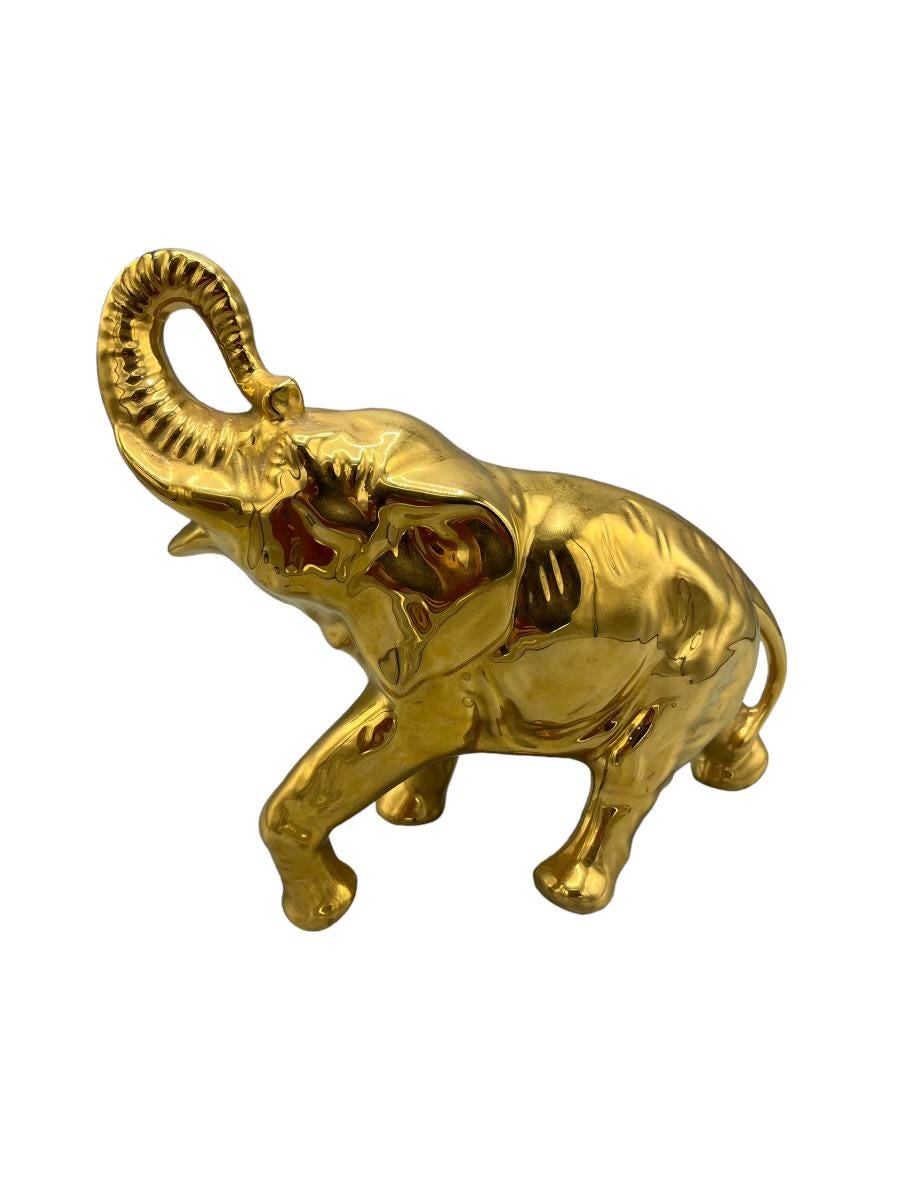 Decorative elephant figurine finished in a shiny gold color and symbolizing good luck