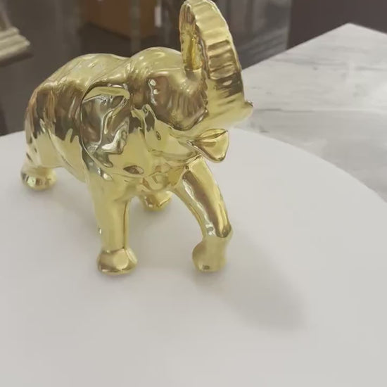 Decorative elephant figurine finished in a shiny gold color and symbolizing good luck