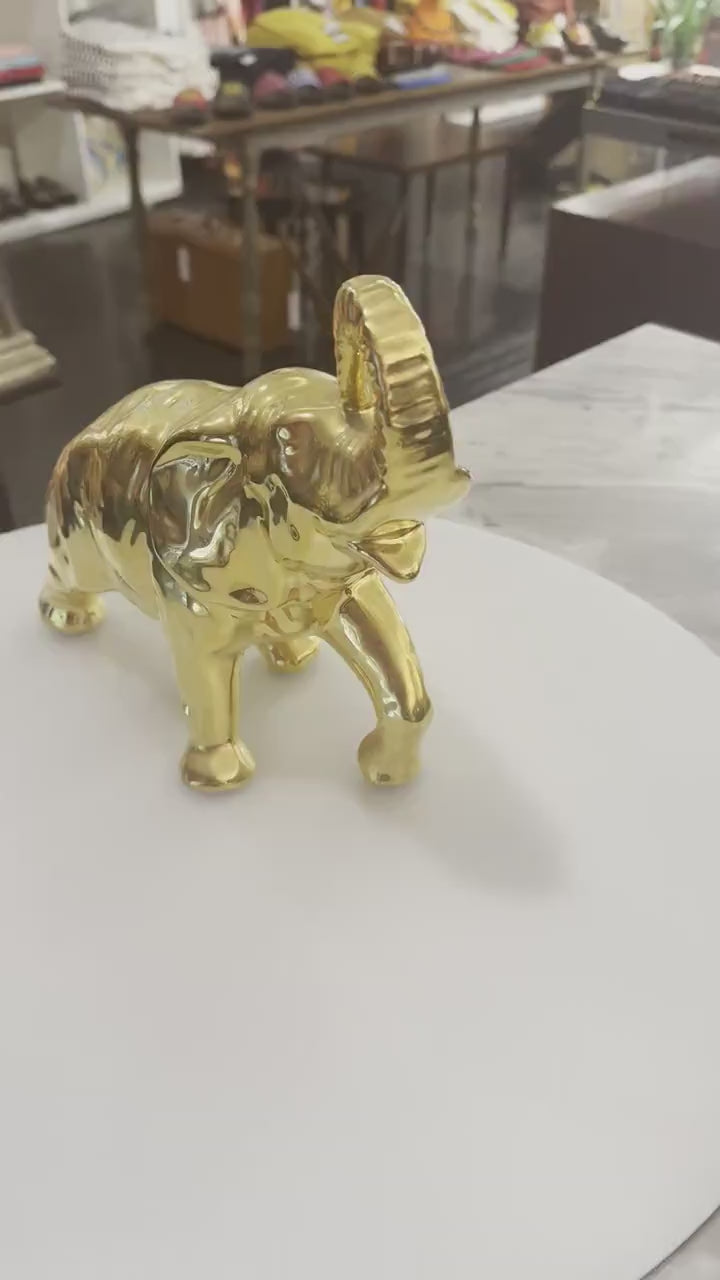 Decorative elephant figurine finished in a shiny gold color and symbolizing good luck