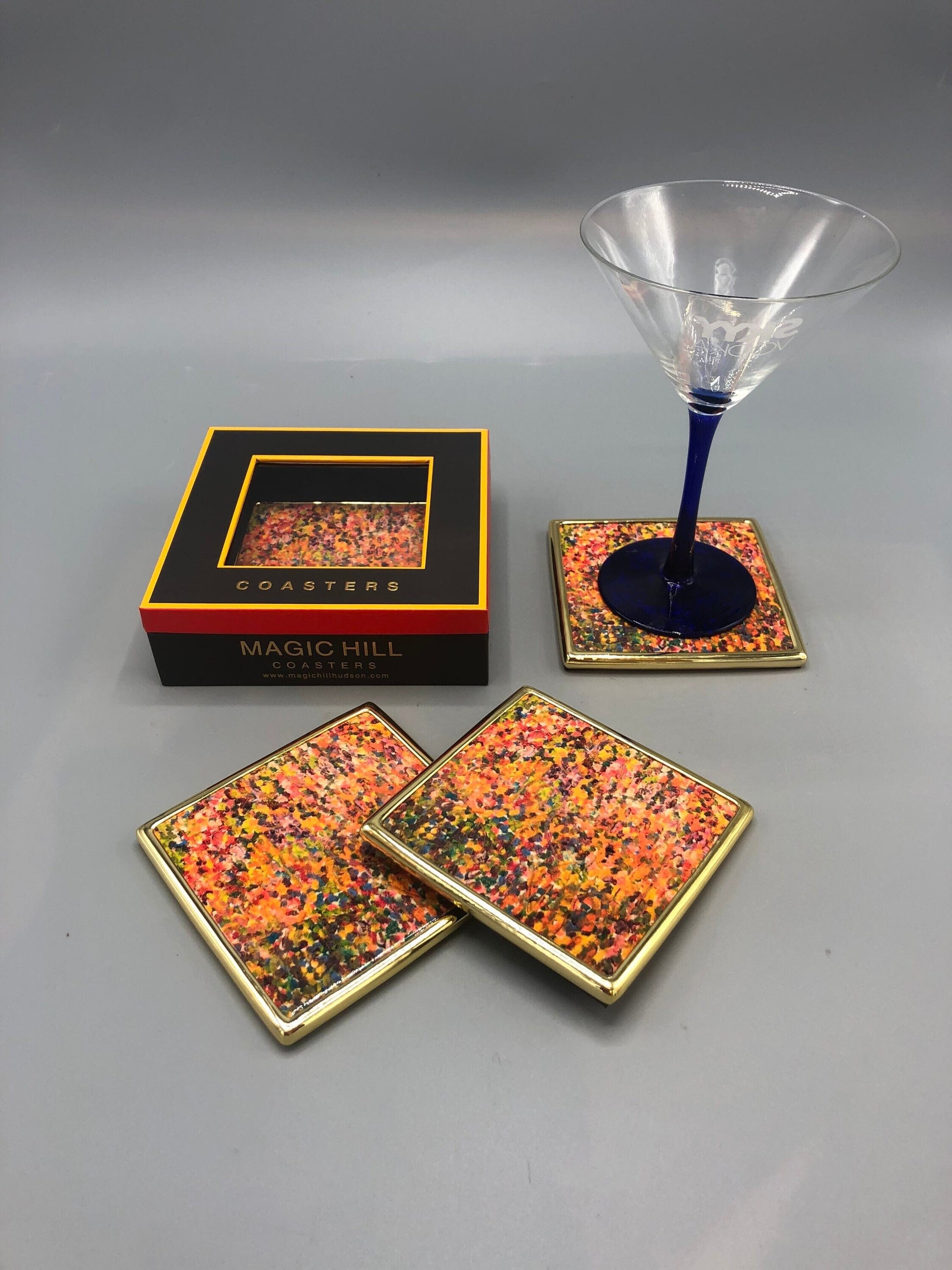 Handmade ceramic coasters with brass trim and velvet on the bottom. Art by Bruce Mishell