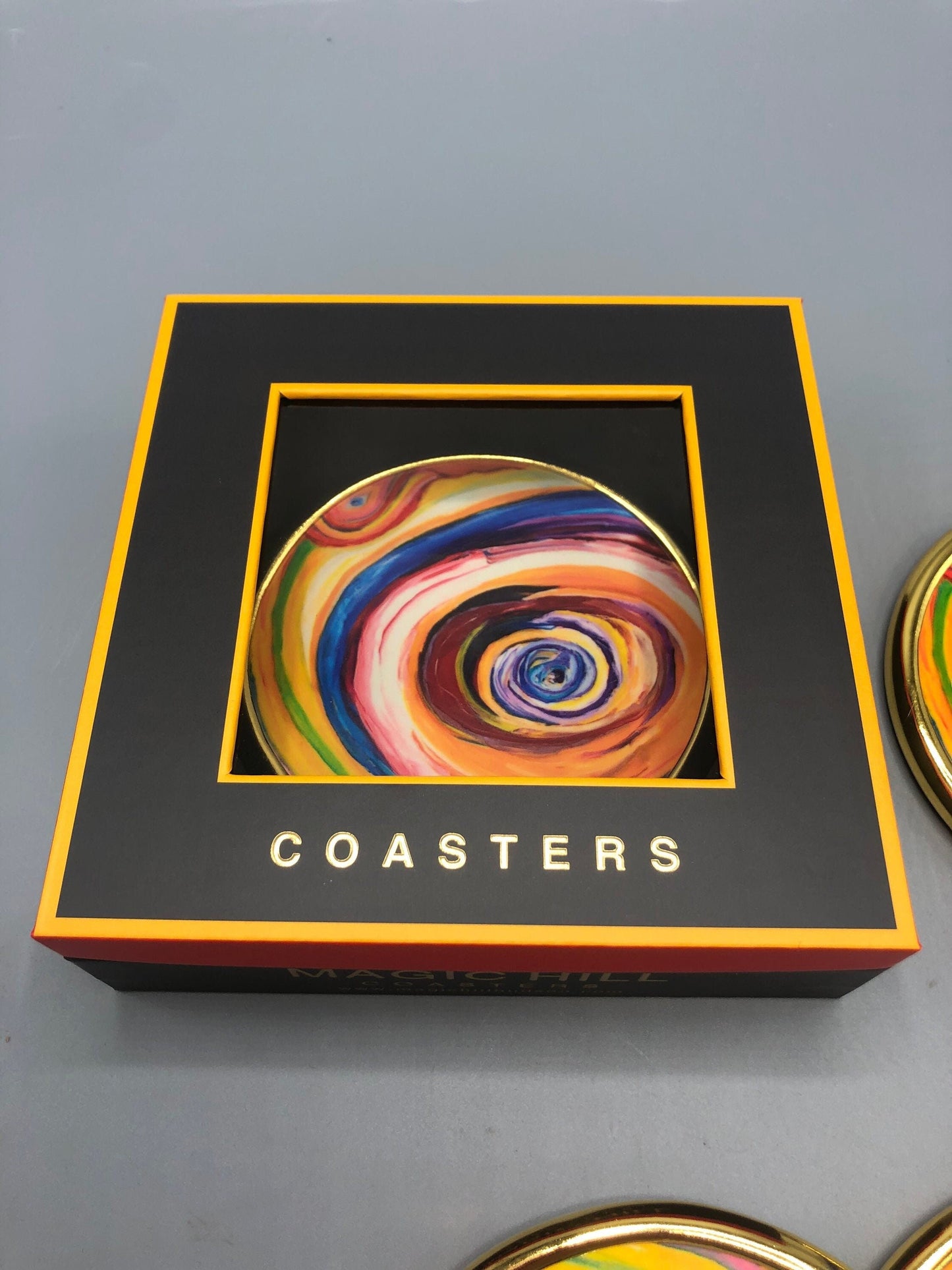 Handmade ceramic coasters with brass trim and velvet on the bottom. art by Bruce Mishell Exclusivity sold by Magic Hill Hudson. 4” inches