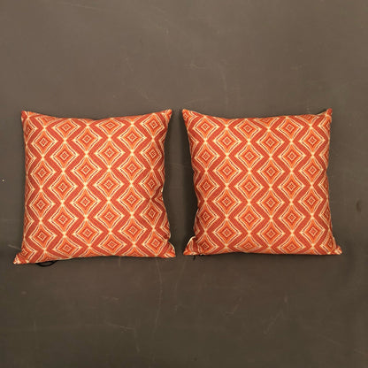 Pair of new hand made modern pillows with geometric orange design.