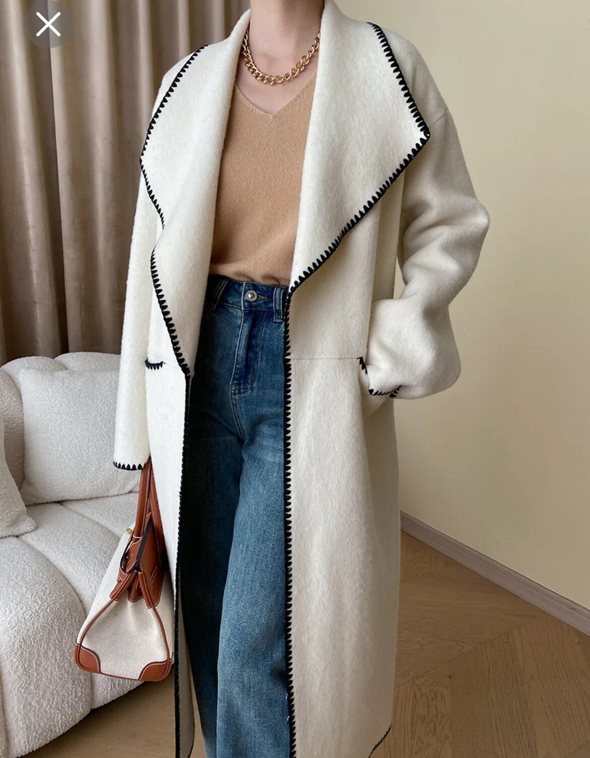 Double breasted hand sew coat in cream with black trim contrast color